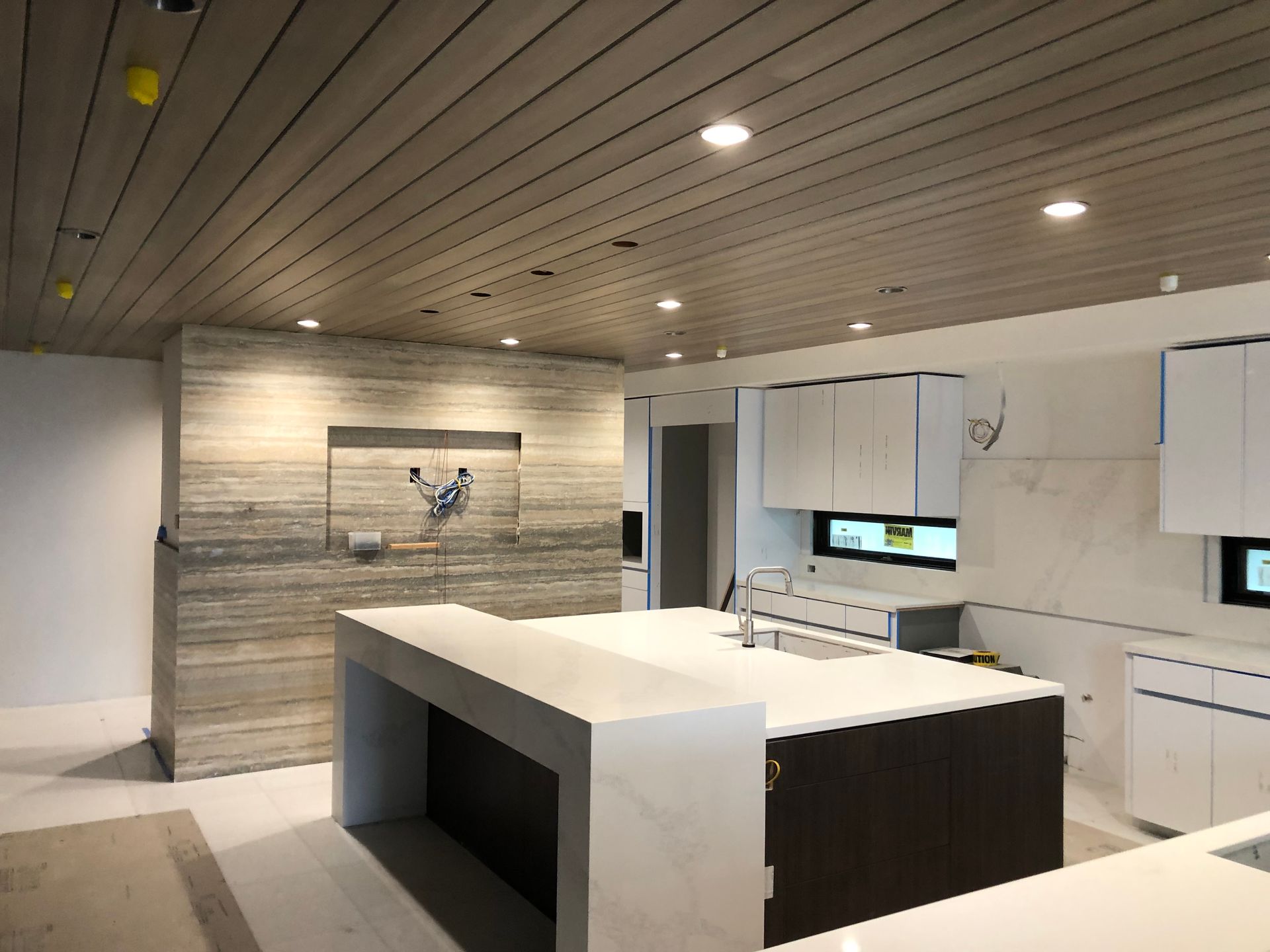 A kitchen with a large island and white cabinets
