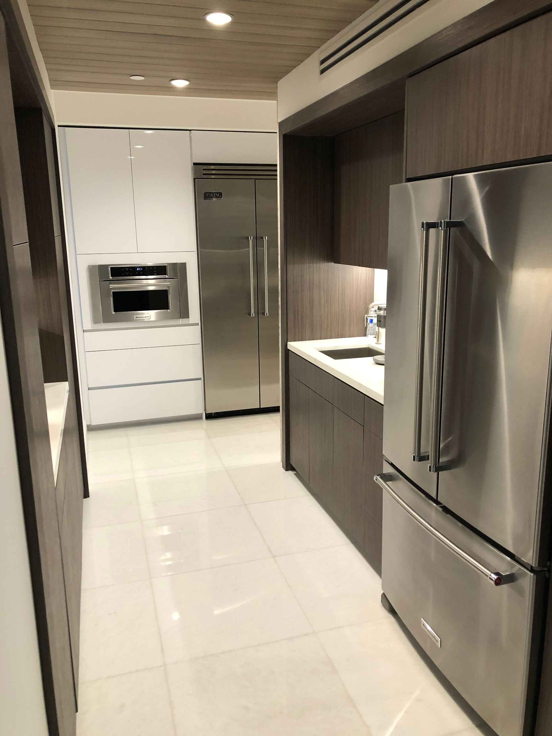 A kitchen with stainless steel appliances and white cabinets