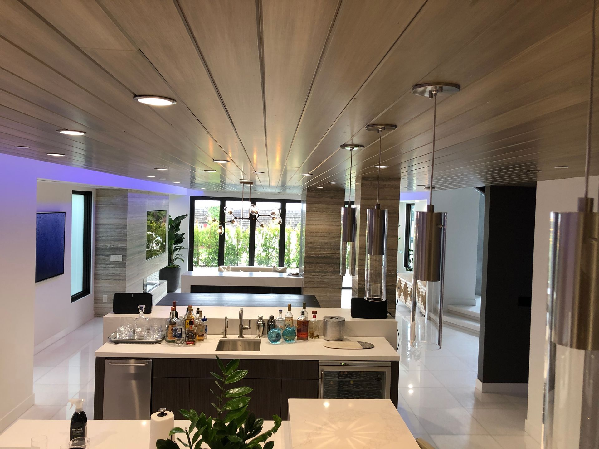 A kitchen with a purple light on the ceiling
