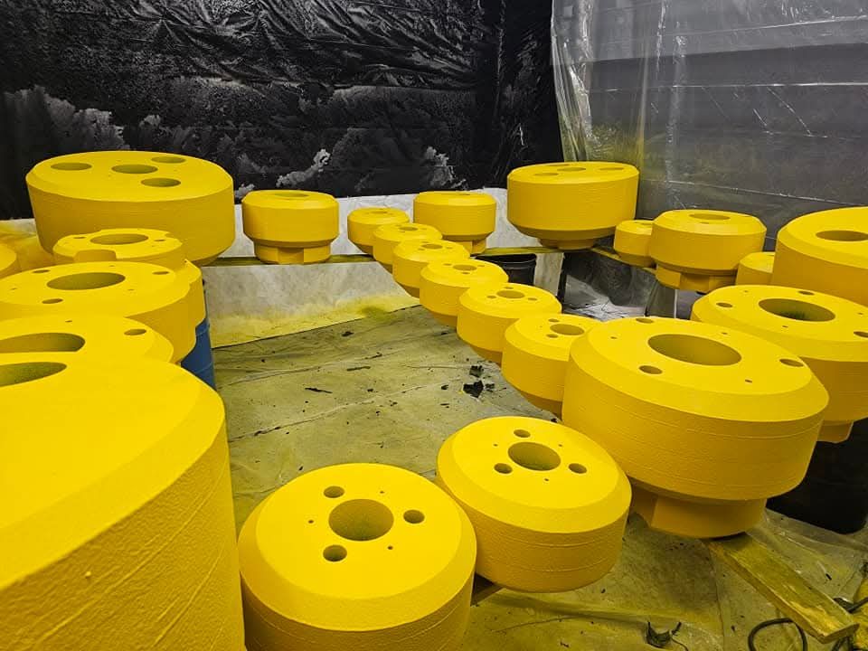 A bunch of yellow circles with holes in them are sitting on a table.