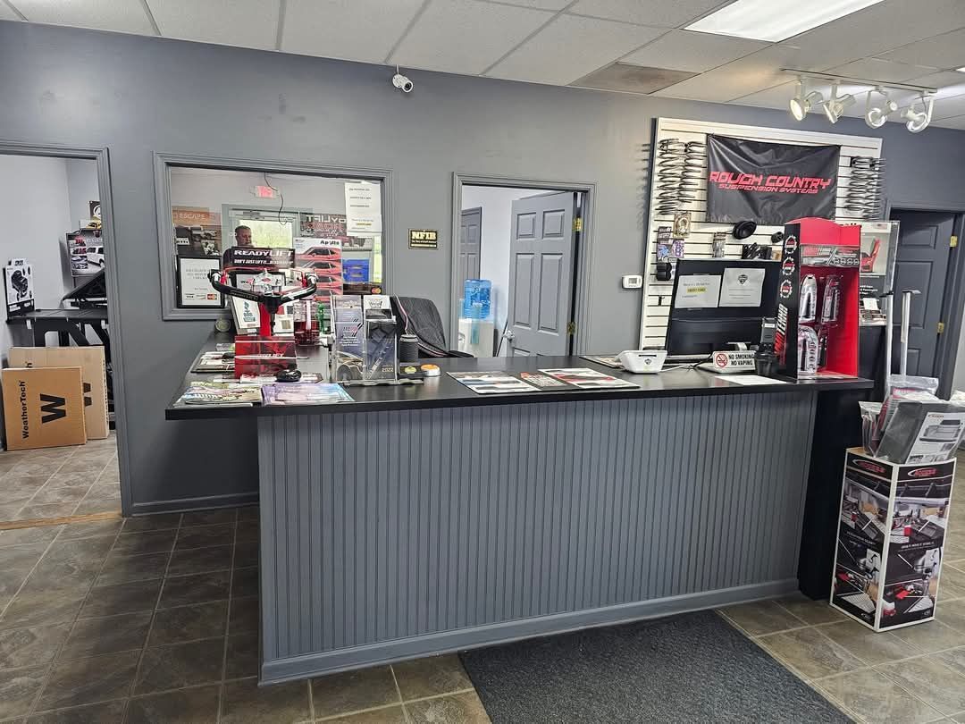 There is a counter in the middle of the room in a store.