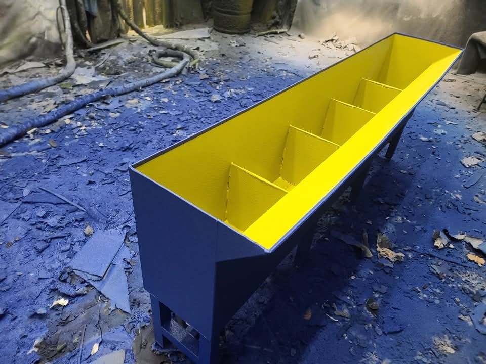 A blue and yellow container is sitting on a blue surface.