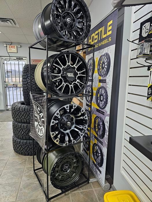 A display of wheels and tires in a store.