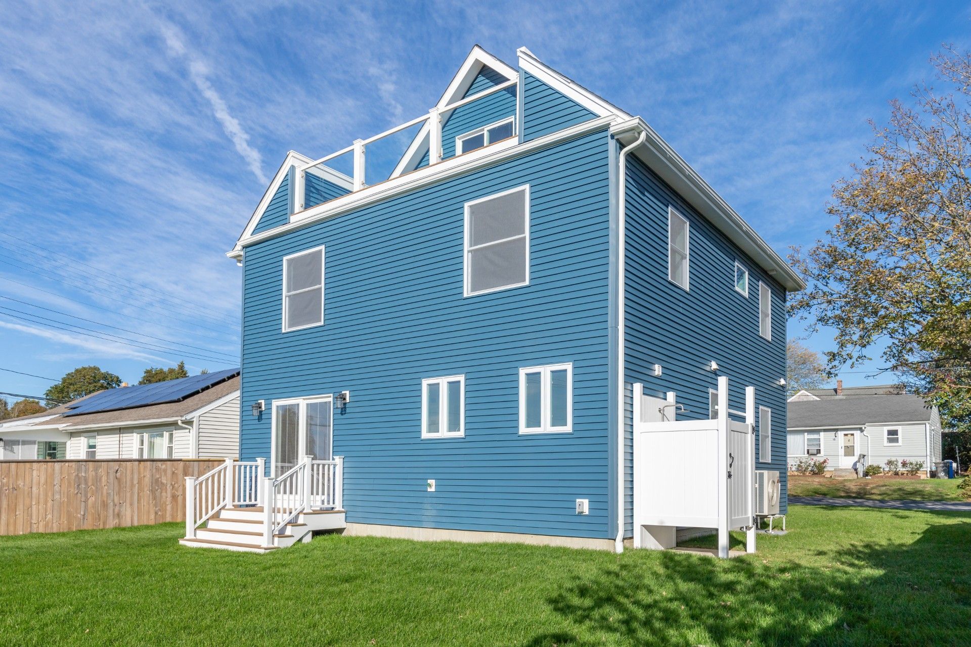 Interior view of a building under construction, showing wooden framing, exposed beams, and reflective insulation.