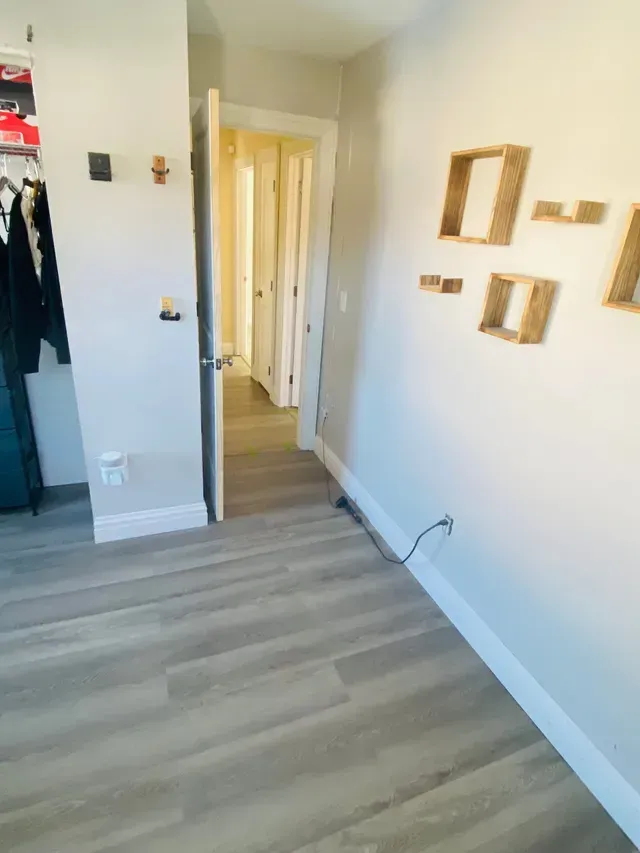 a room with a wooden floor and white walls