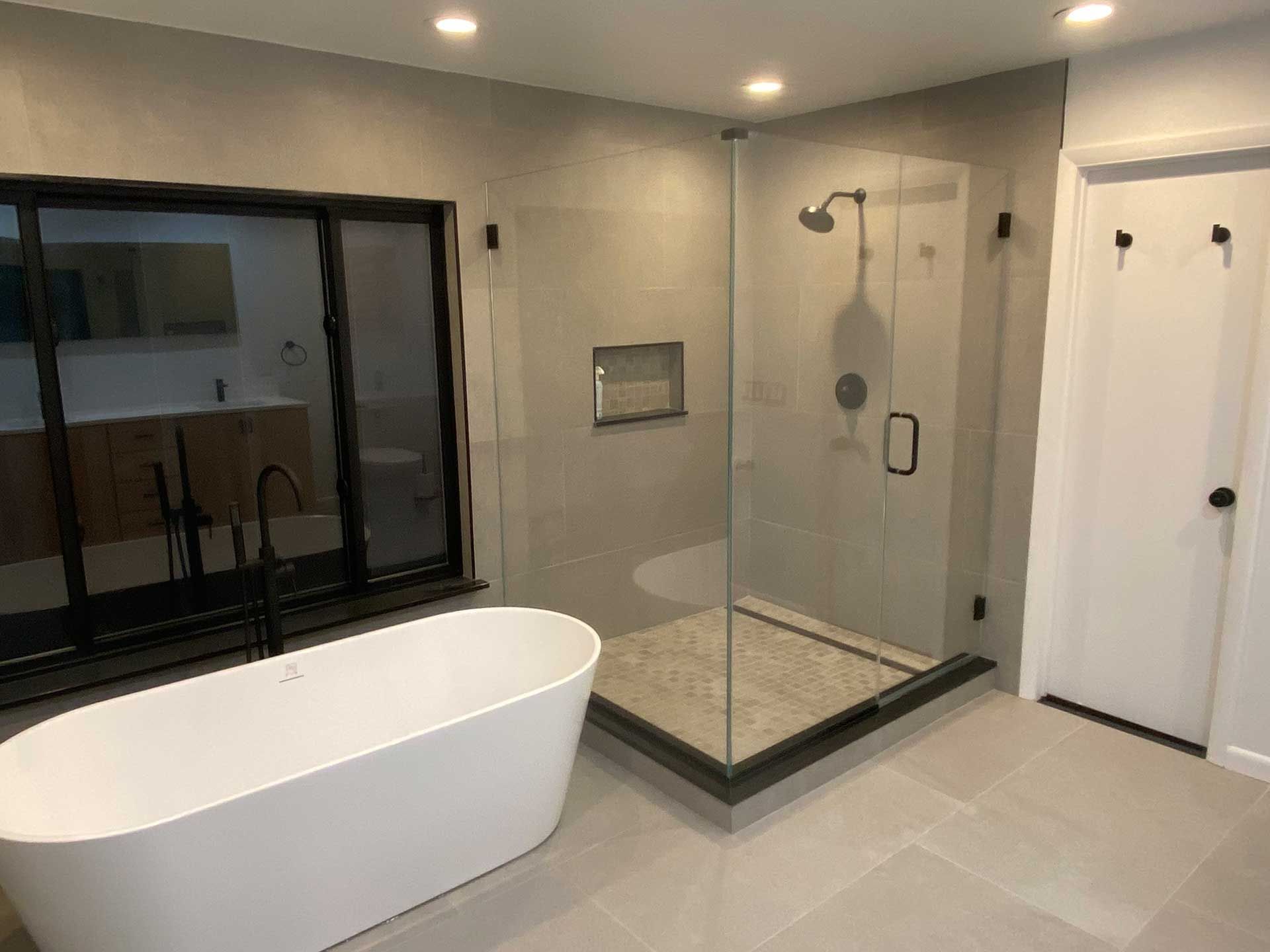 bathroom with a farmhouse-style bathtub and shower enclosure