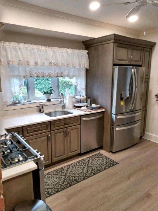 A kitchen with stainless steel appliances and wooden cabinets