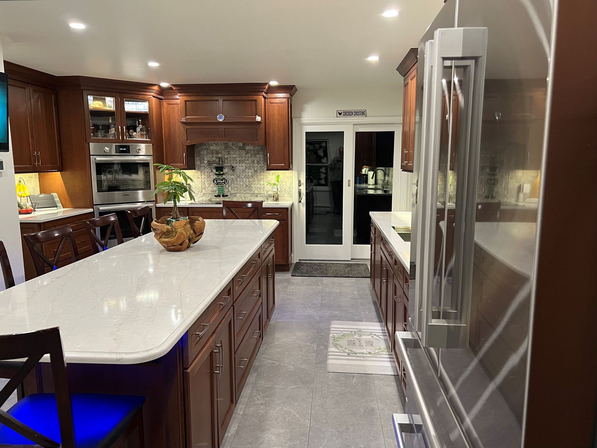 a kitchen with a large island and stainless steel appliances