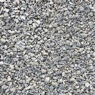 A pile of gravel is sitting on the ground.