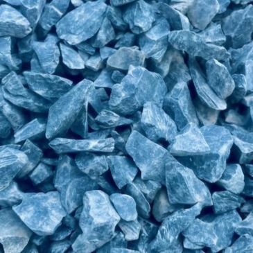 A pile of blue rocks is sitting on the ground