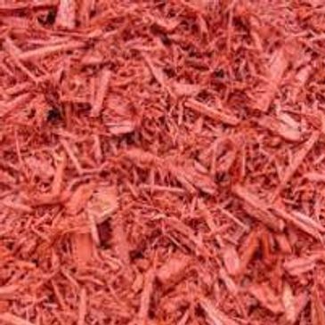 A pile of red mulch is sitting on the ground.