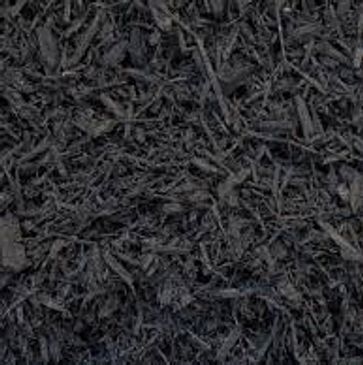 A close up of a pile of black mulch.