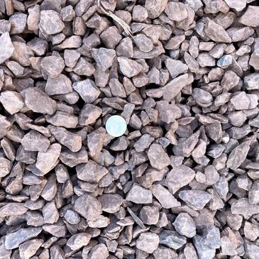 A pile of rocks with a coin in the middle.