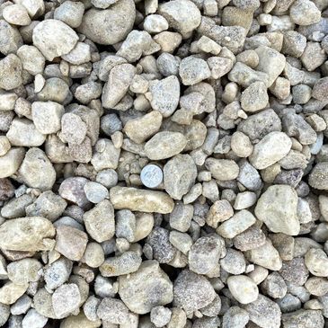 A pile of rocks with a coin in the middle.