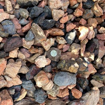 A pile of rocks with a coin in the middle.