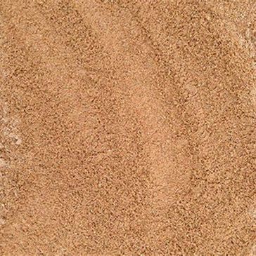 A close up of a pile of brown sand.
