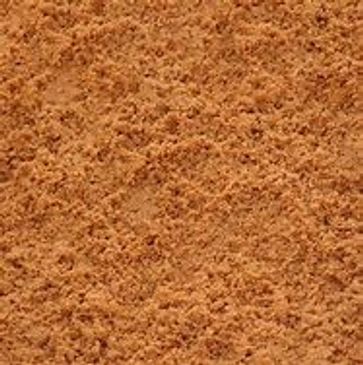 A close up of a pile of brown sand.