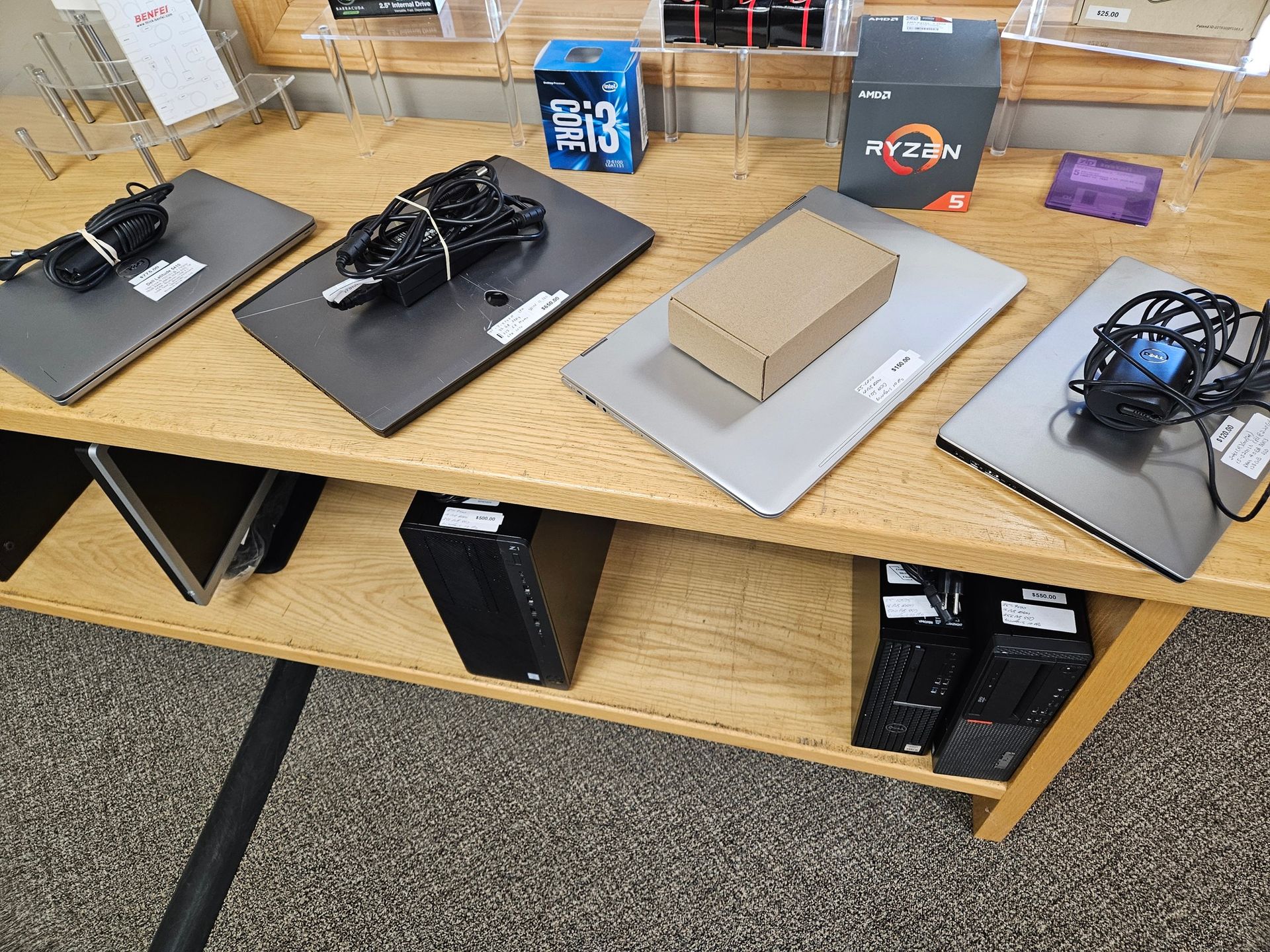 A wooden table with a bunch of laptops on it