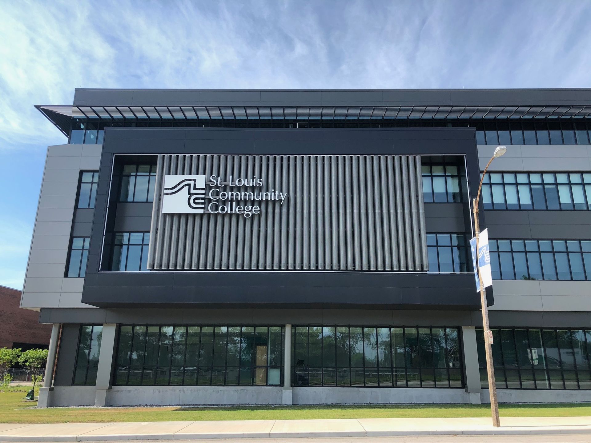 A large building with a sign on the side that says community college