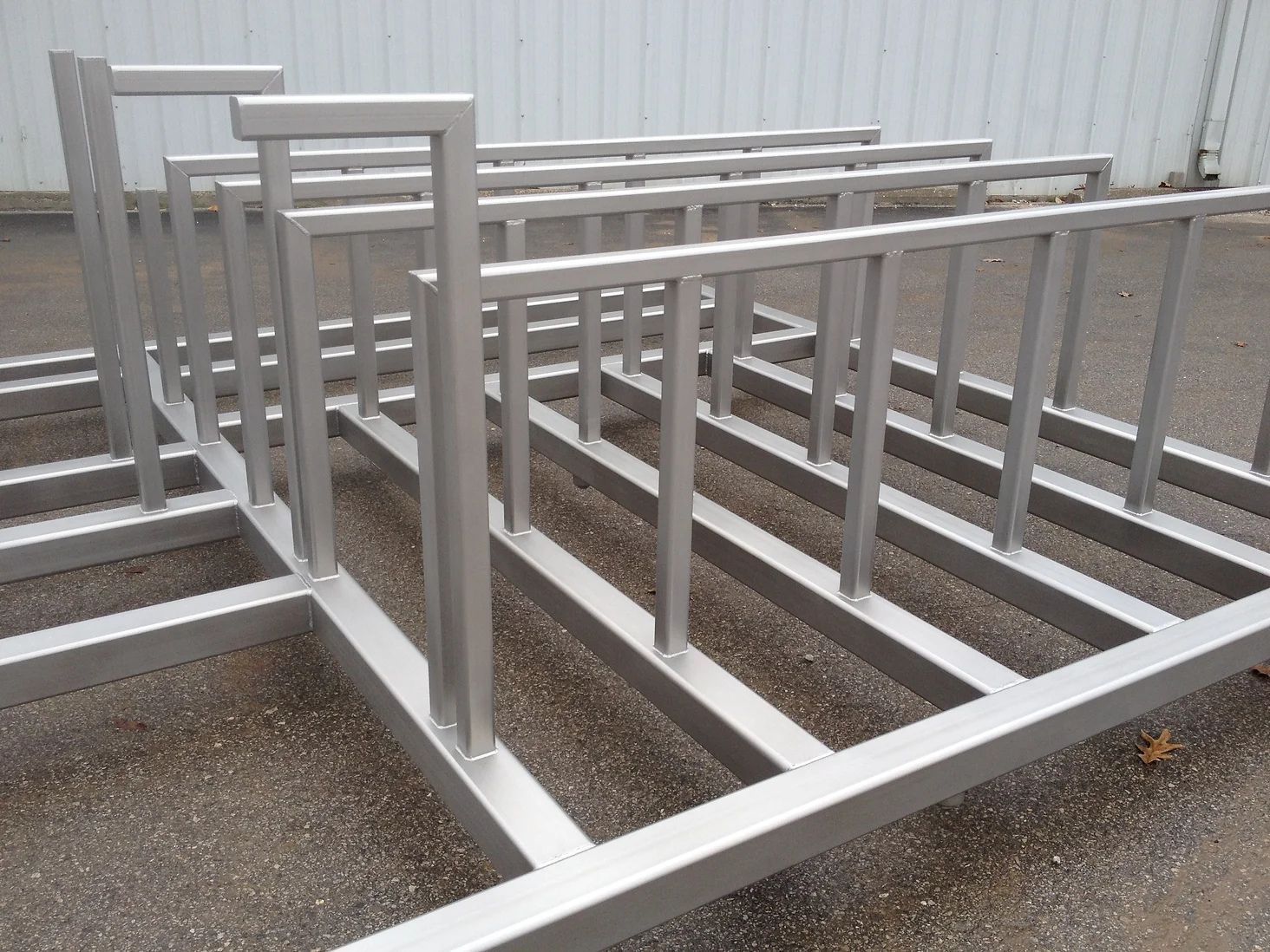 A bunch of metal frames are sitting on the ground.