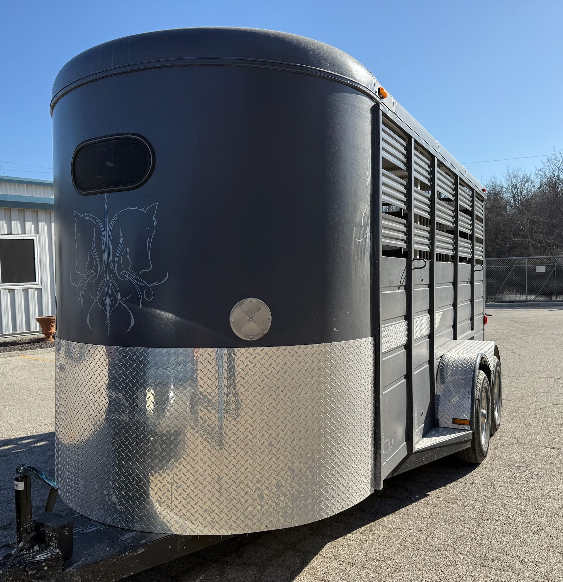 A black and silver horse trailer