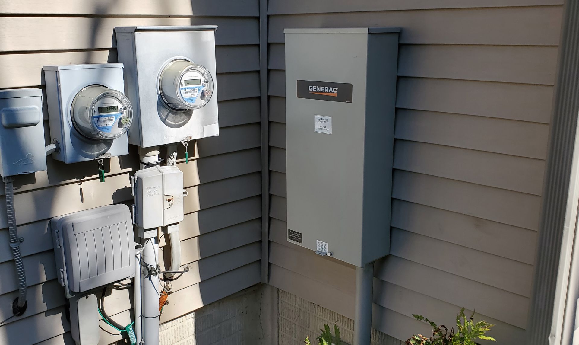 a row of electrical boxes on the side of a house