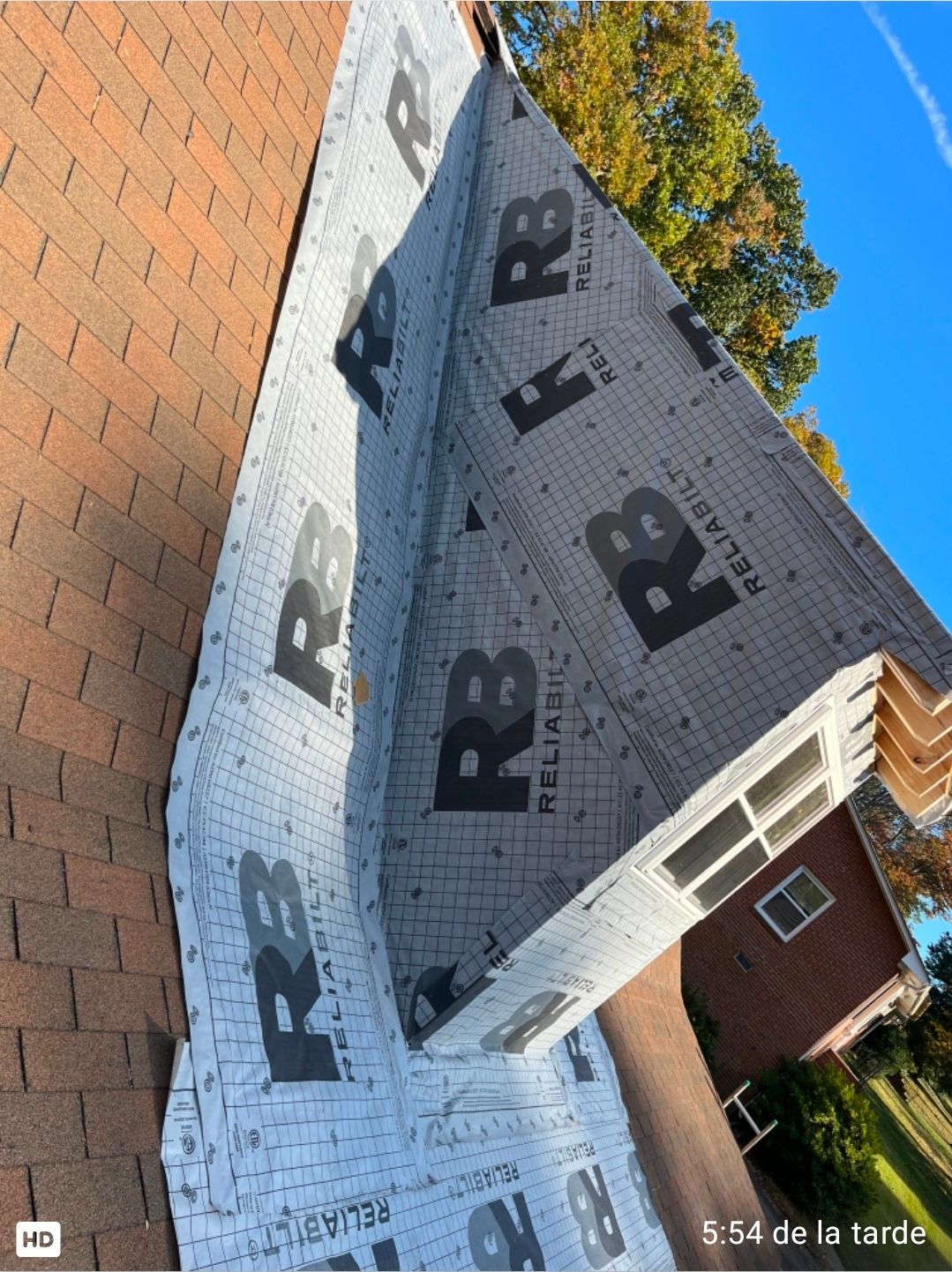 Roof under construction with gray underlayment and black 
