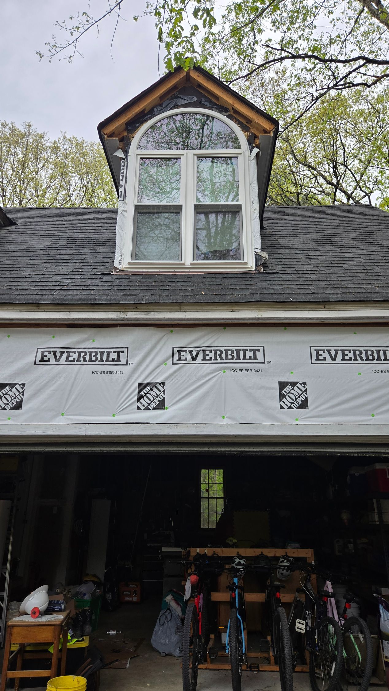 Bike shop storefront with slate roof and dormer window, bicycles displayed at the entrance