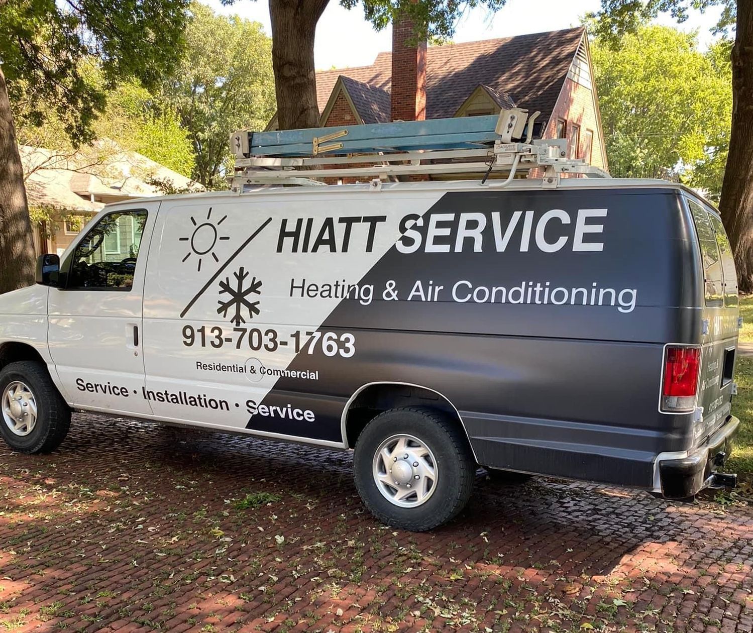 White Hiatt Service van with black accents; parked outdoors, heating and air conditioning service.