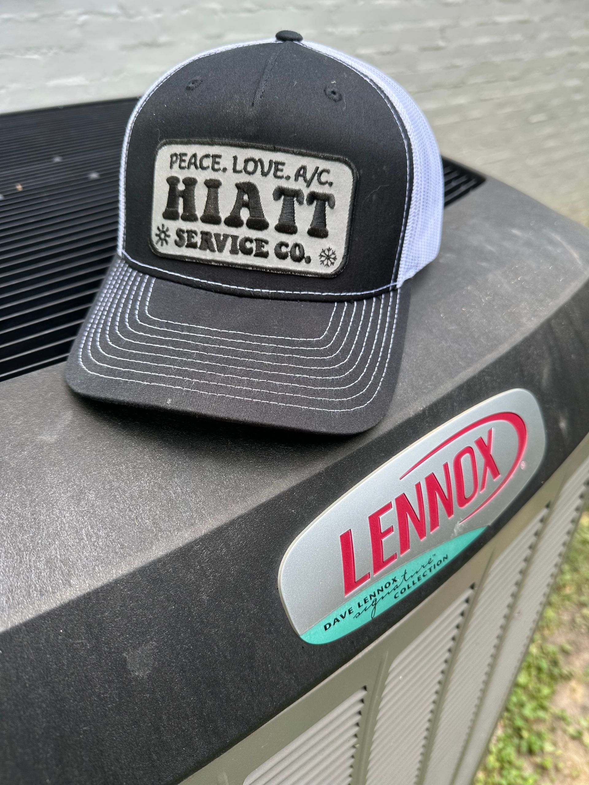 Hat with Hiatt Service Co. logo on a Lennox air conditioning unit.