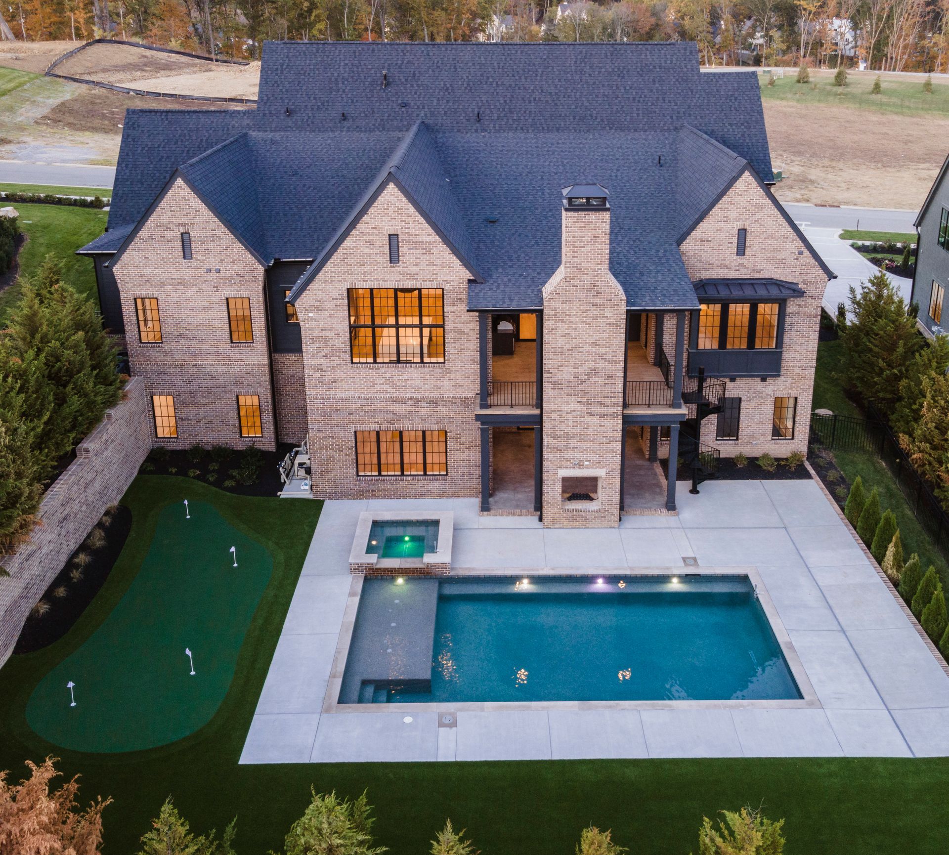 An aerial view of a large house with a large swimming pool