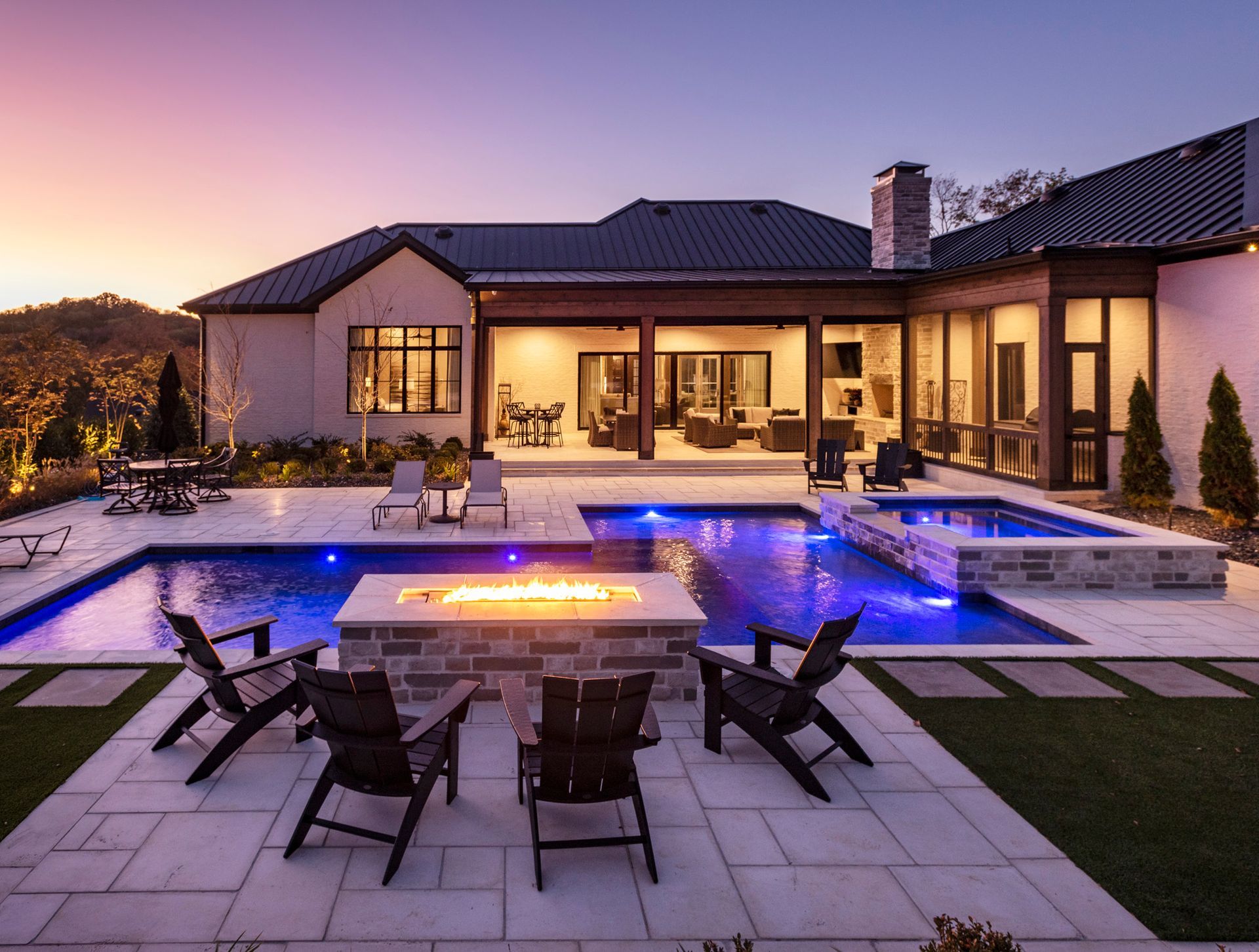 A large house with a swimming pool and a fire pit