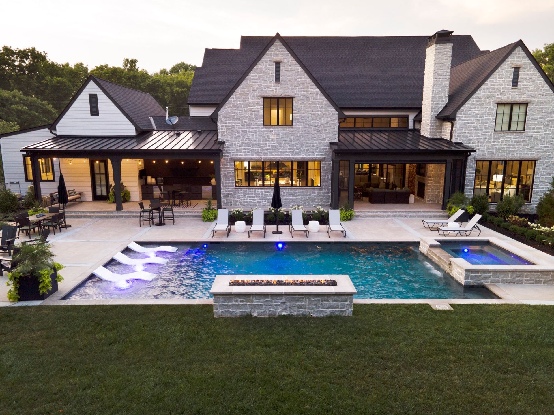 A large house with a large swimming pool in front of it