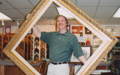 man holding big frame