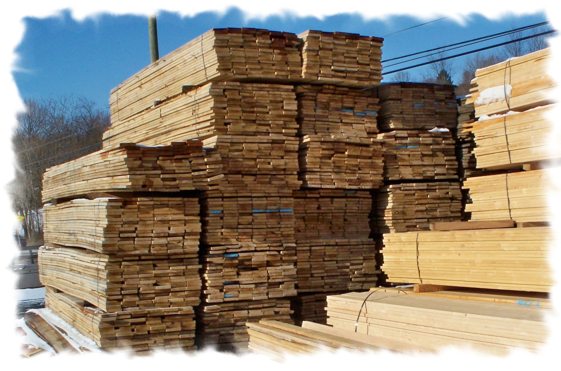 A stack of wooden boards with blue labels on them