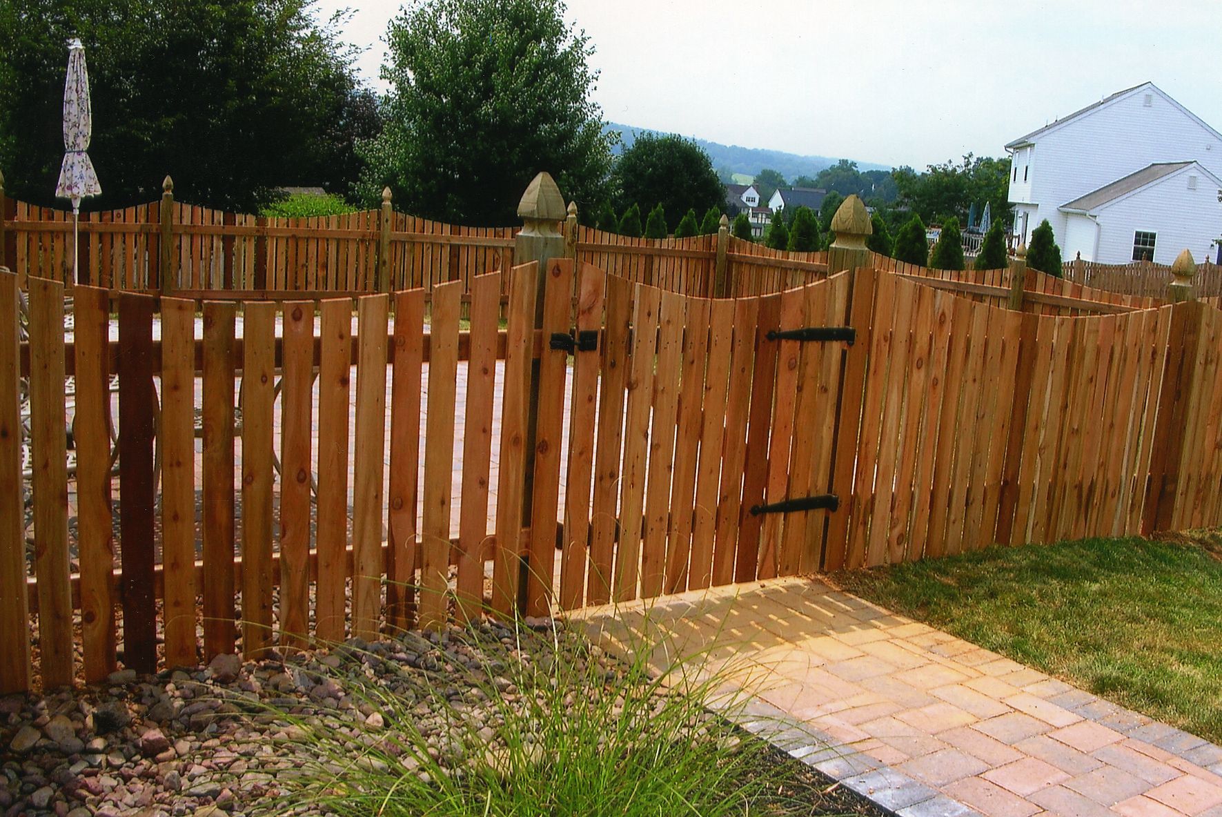 A wooden fence with a gate in the backyard
