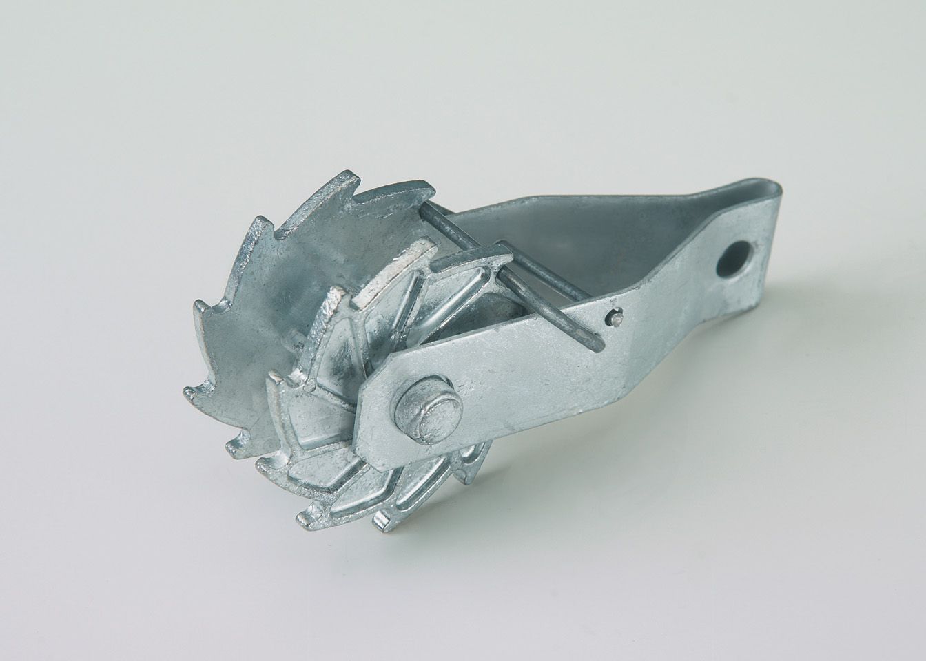 A close up of a metal object on a white surface.