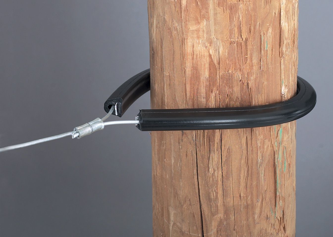 A wooden pole with a wire attached to it.