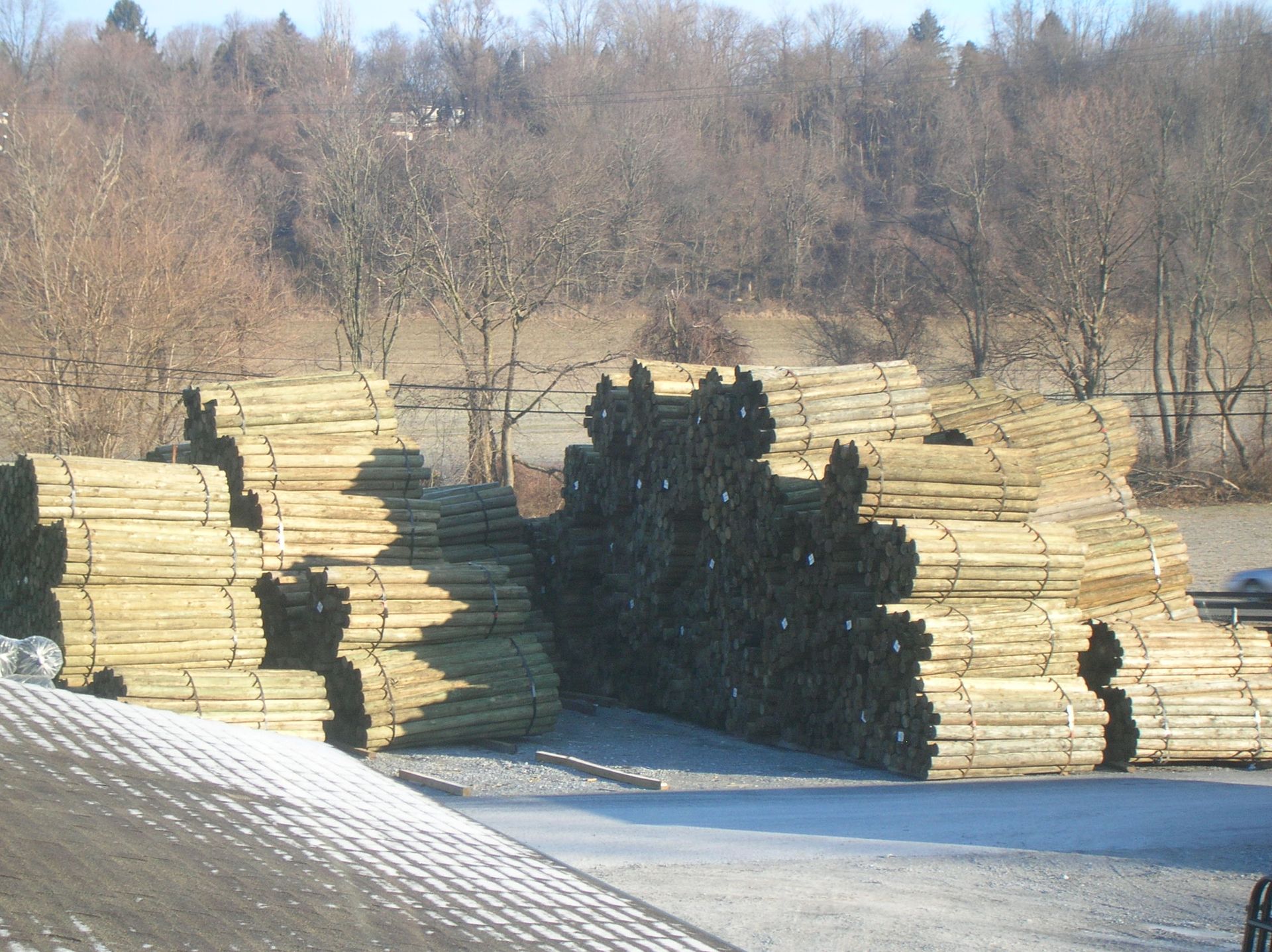 A large pile of wood is stacked on top of each other