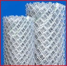 A close up of two rolls of chain link fence on a blue background.