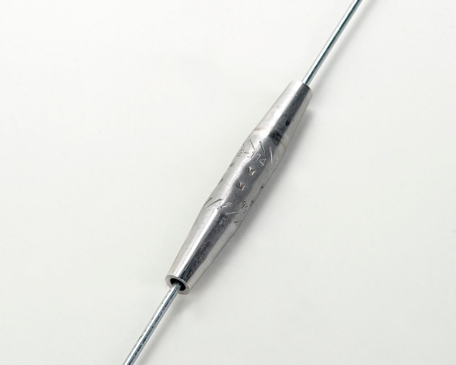 A close up of a metal object on a white surface