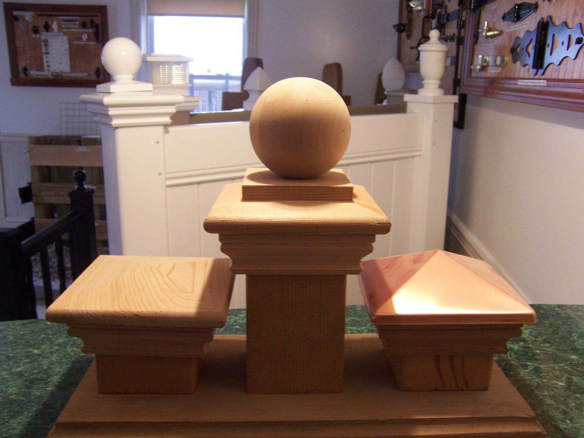 A wooden post with a ball on top of it