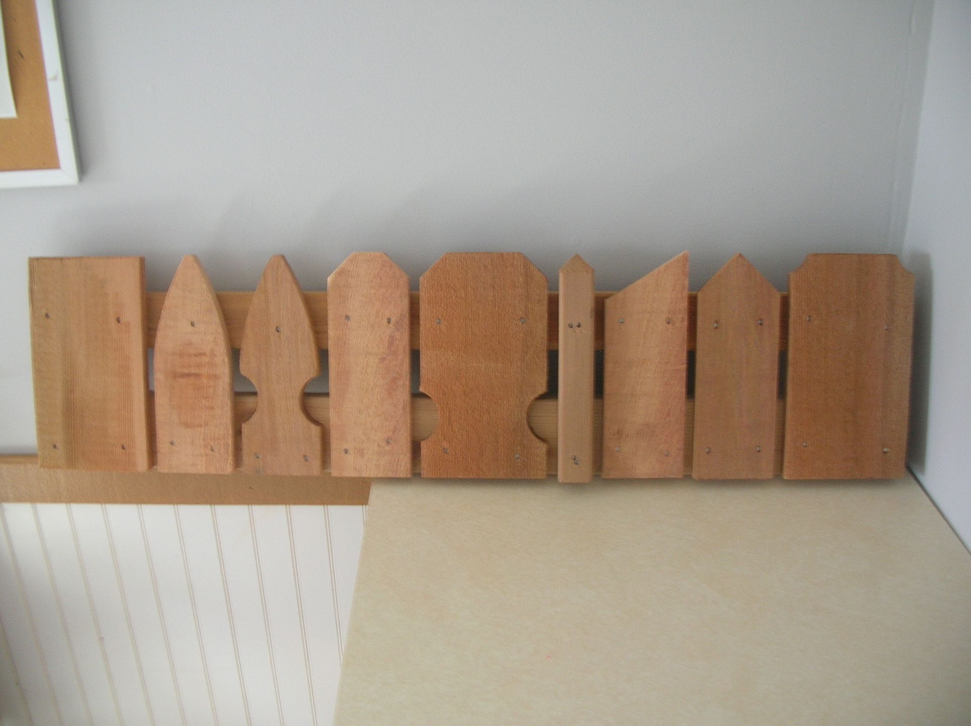 A row of wooden fence pieces sitting on a table