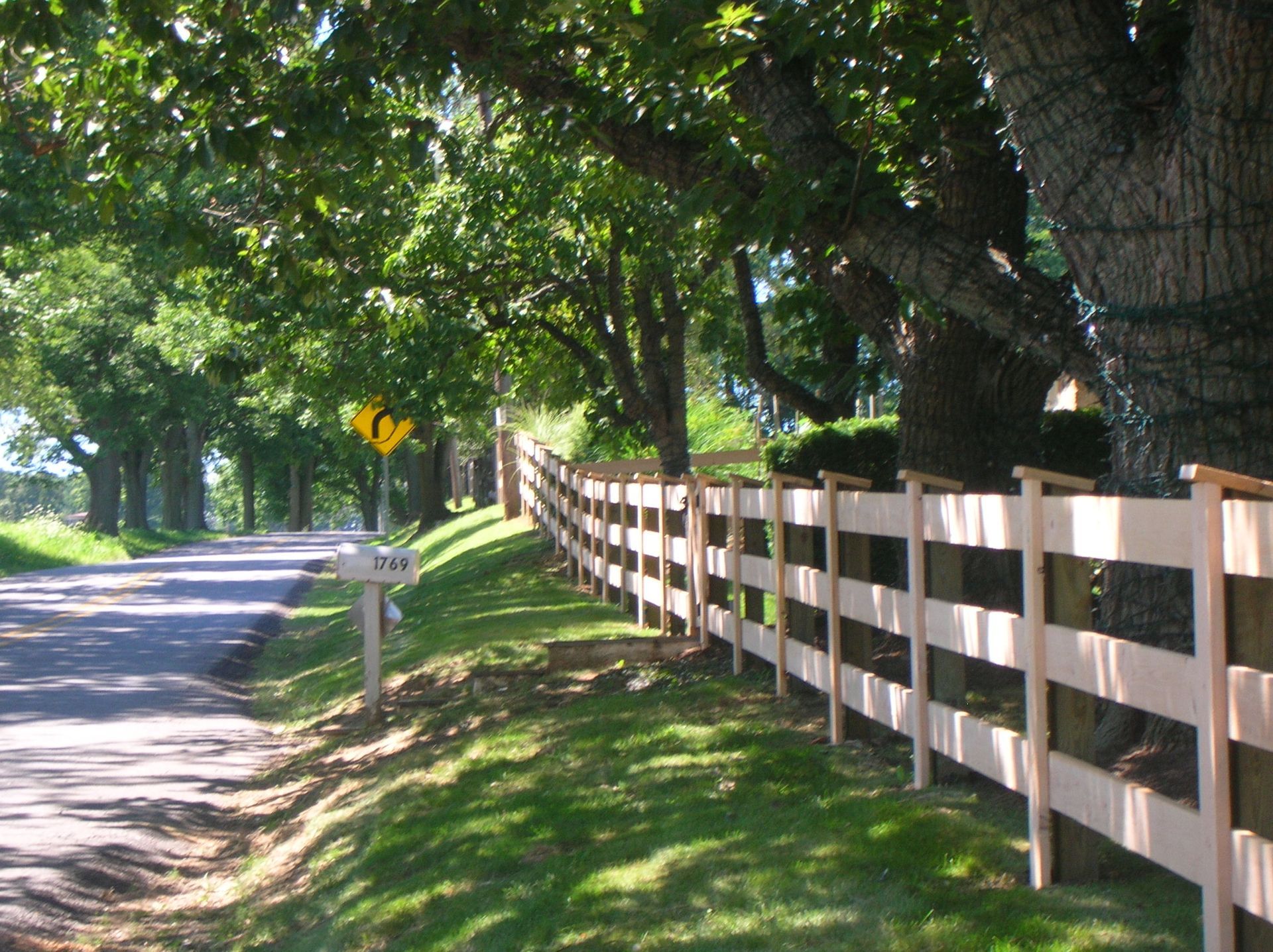 A wooden fence along the side of a road
