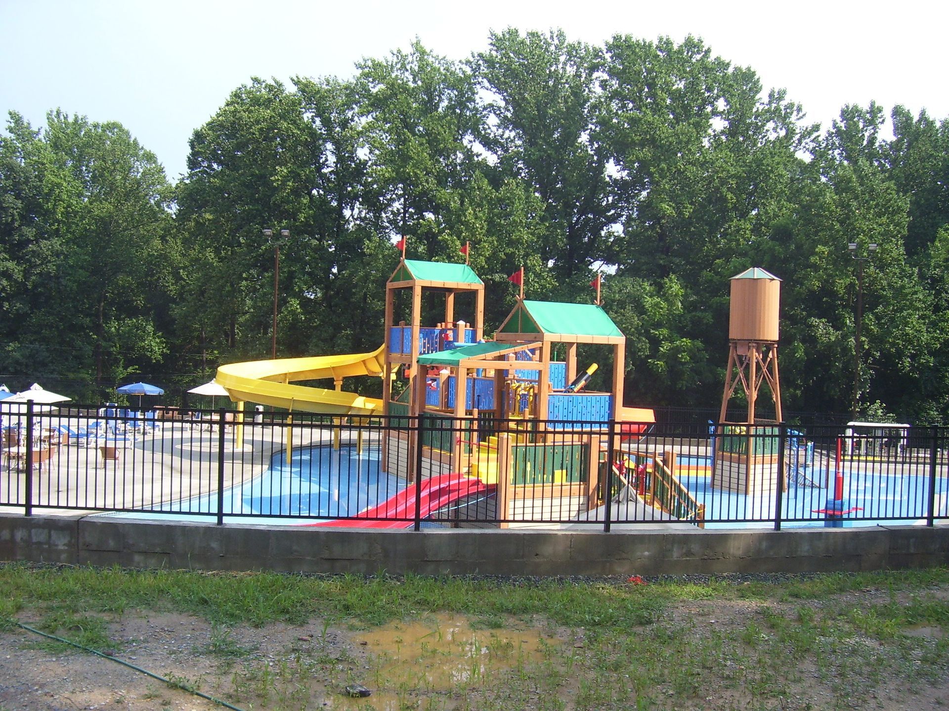 A water park with a water slide and a water tower