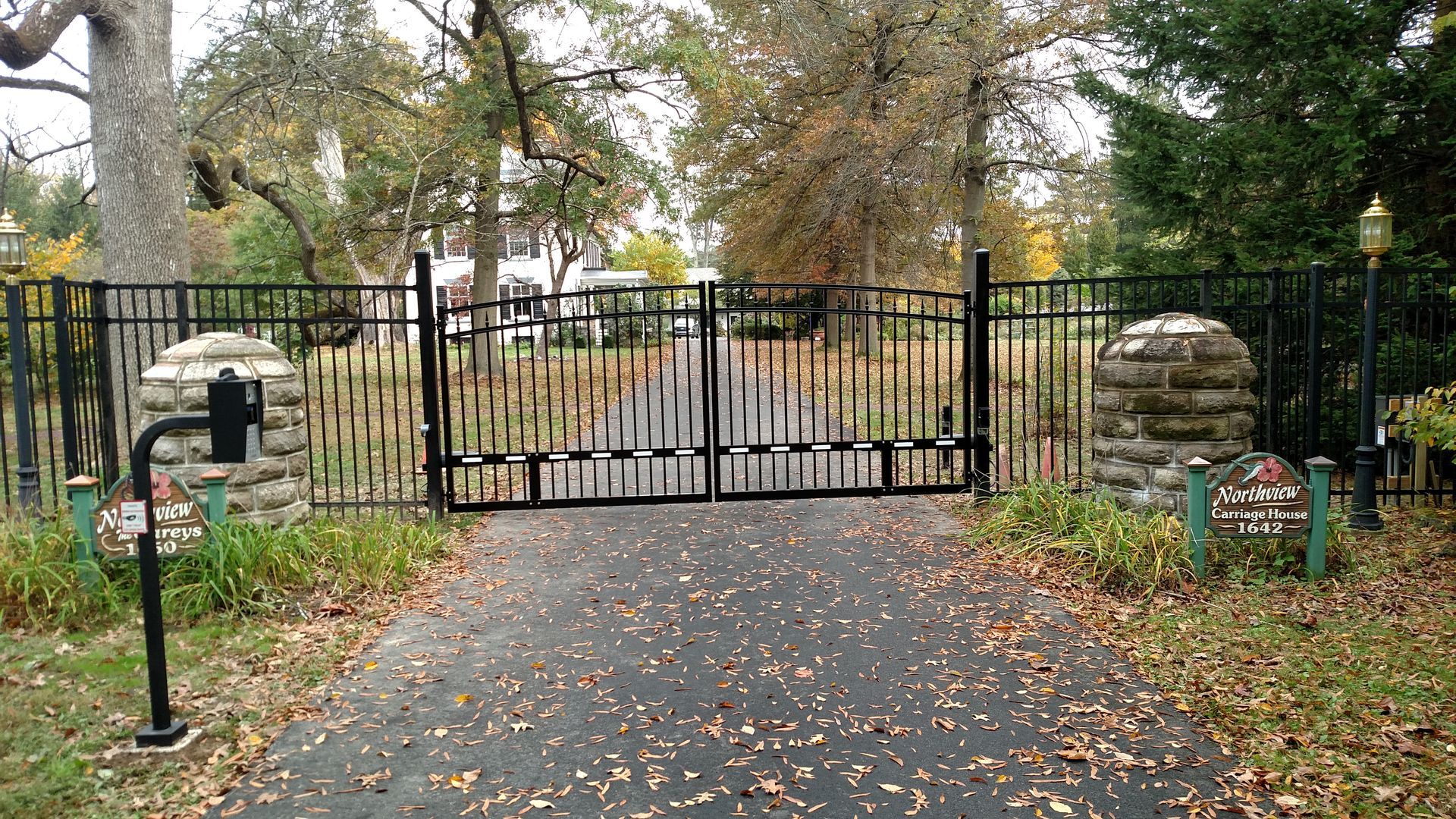 There is a gate on the side of the road.