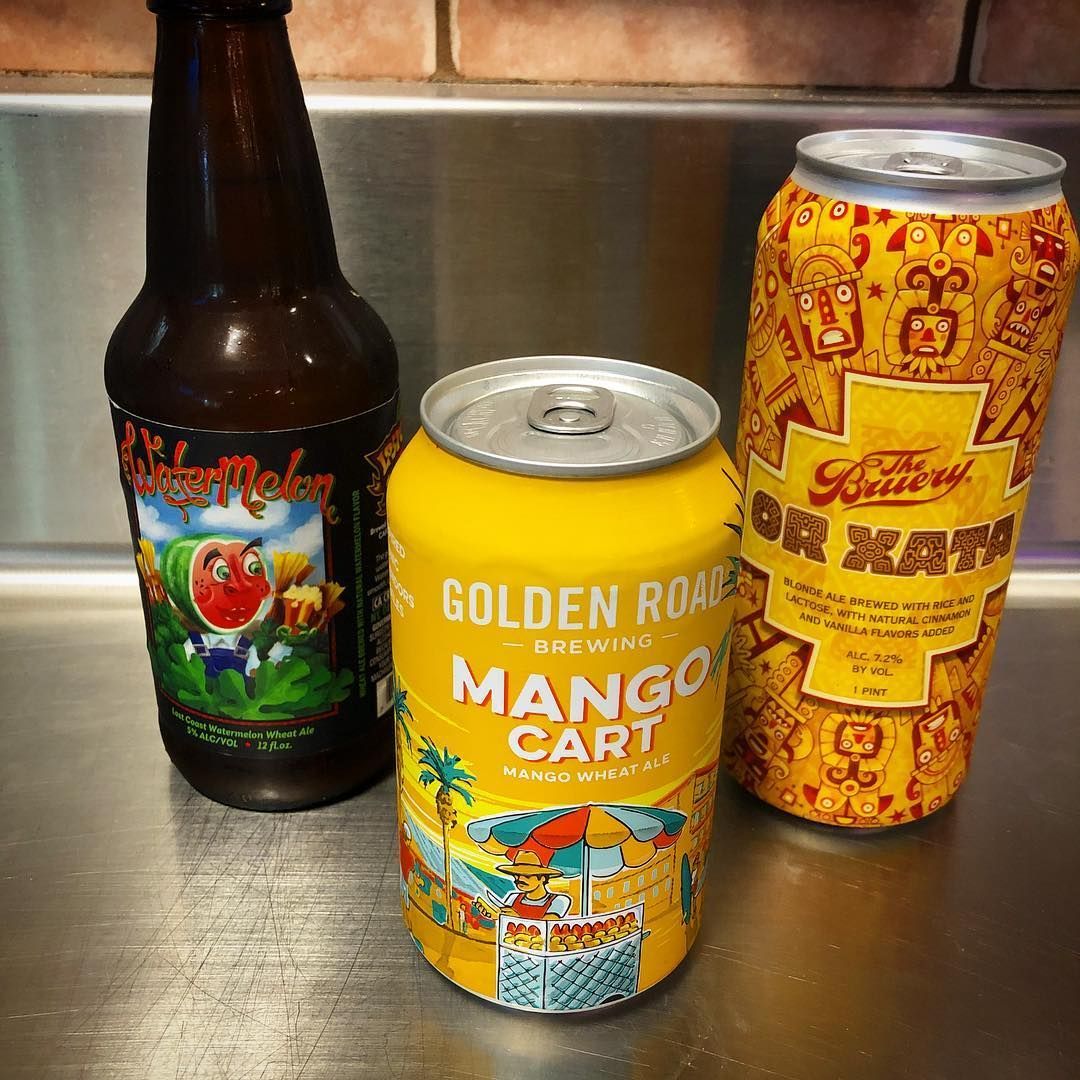 Three beverage containers: a bottle, a yellow can labeled 