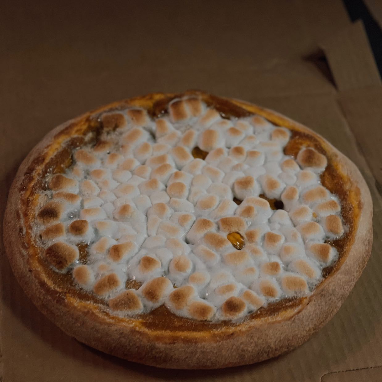 Pizza with a layer of browned marshmallows.