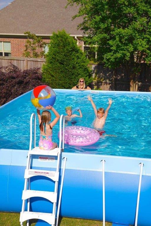 A group of children are playing in a swimming pool