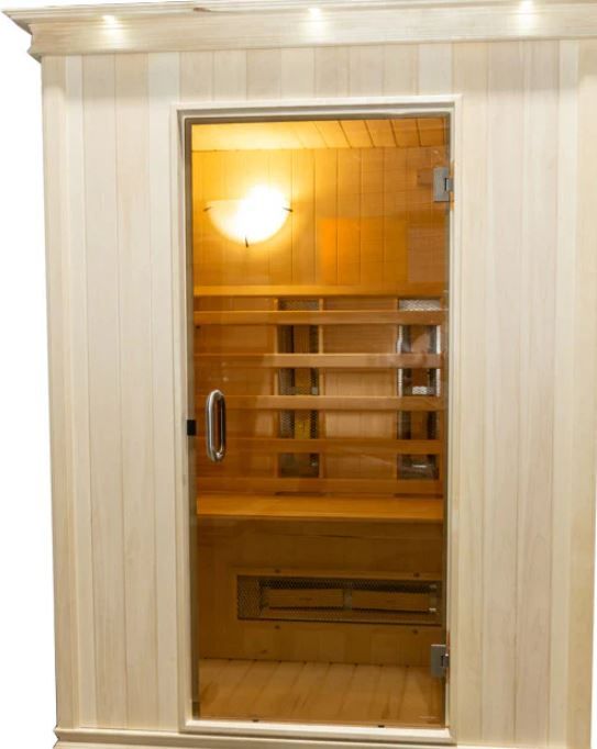 A white wooden sauna with a glass door